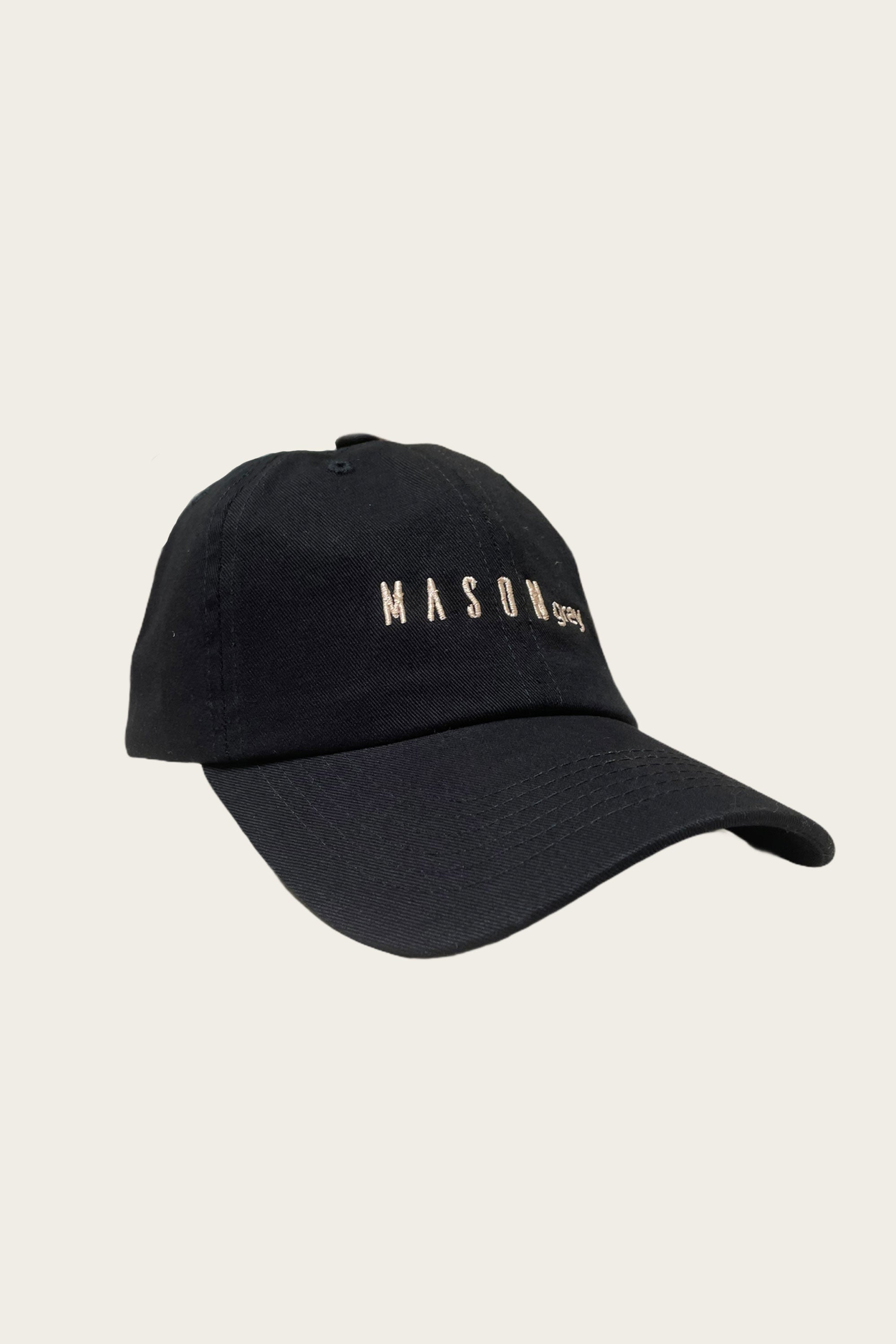 Load image into Gallery viewer, photo of a black hat with &quot;MASONgrey&quot; written on the front in tan lettering
